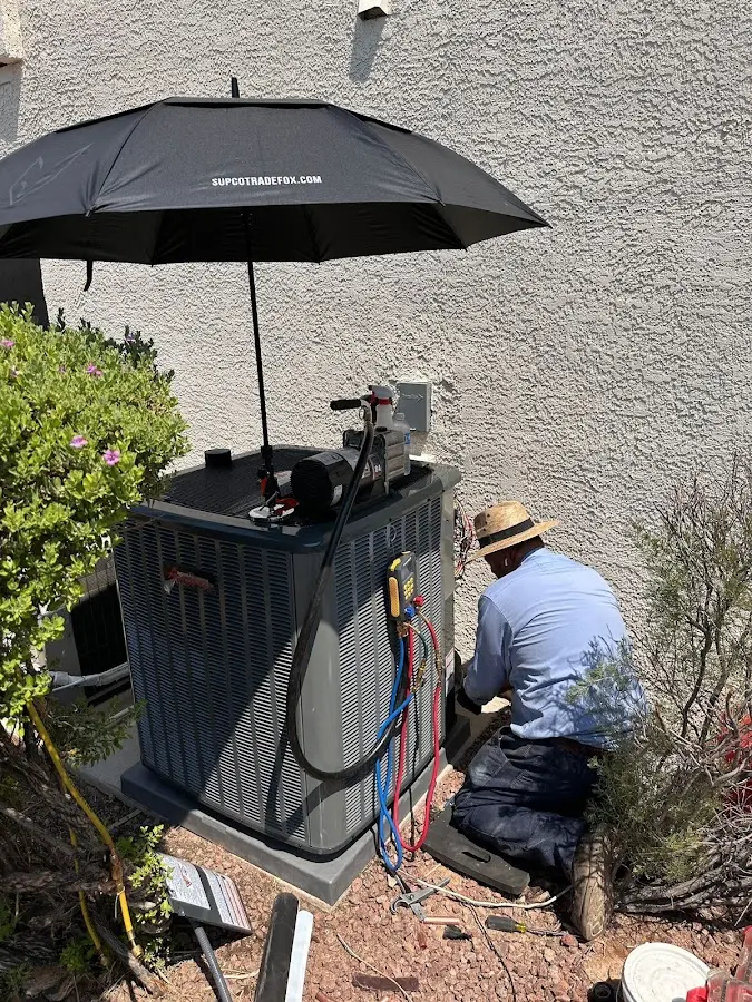 HVAC technician performing outdoor AC maintenance in Collegeville